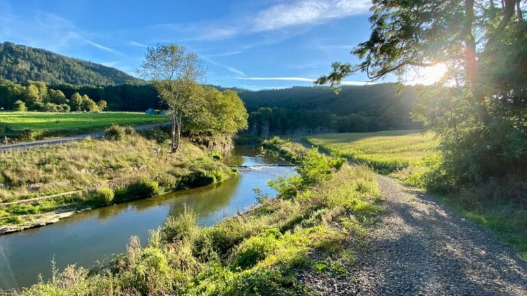Ahr river with the Prümer Tor cliffs in the background on the AhrSteig in the Ahr Valley