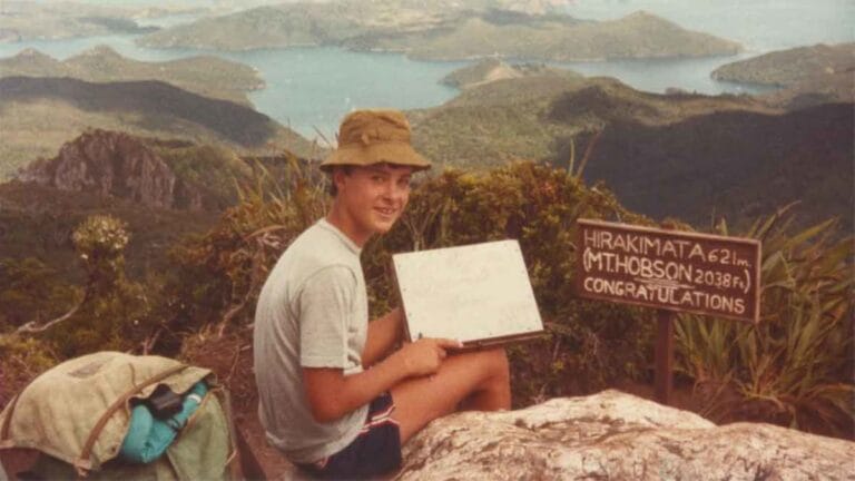 DeWandelaar sitting at the summit of Hirakimata or Mt. Hobson on Great Barrier Island in the early 1980s