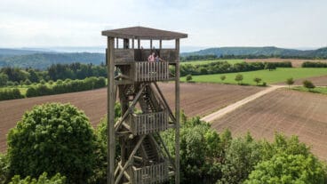 Two hikers standing atop the Zemmer viewing tower near Rodt